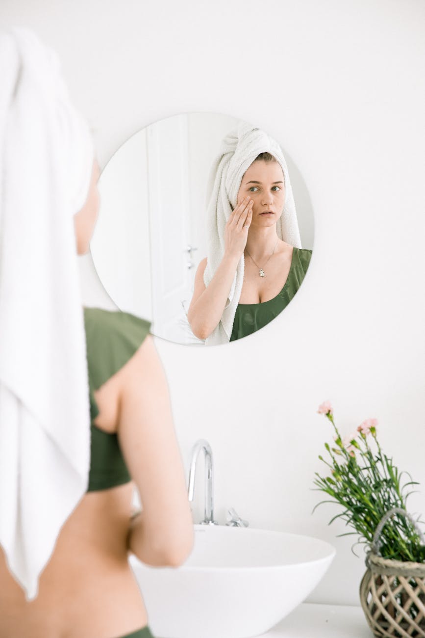 photo of woman looking in the mirror