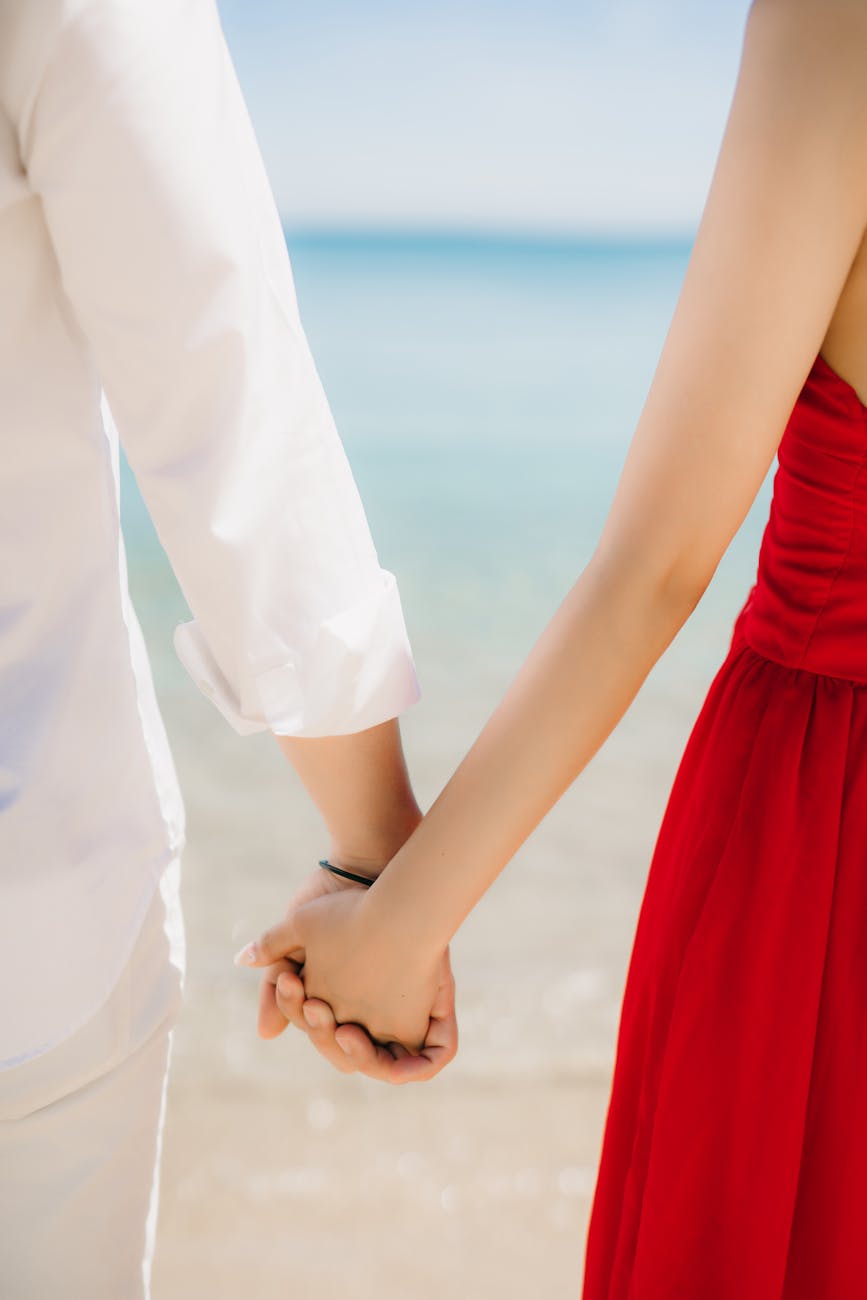 couple holding hands on the beach