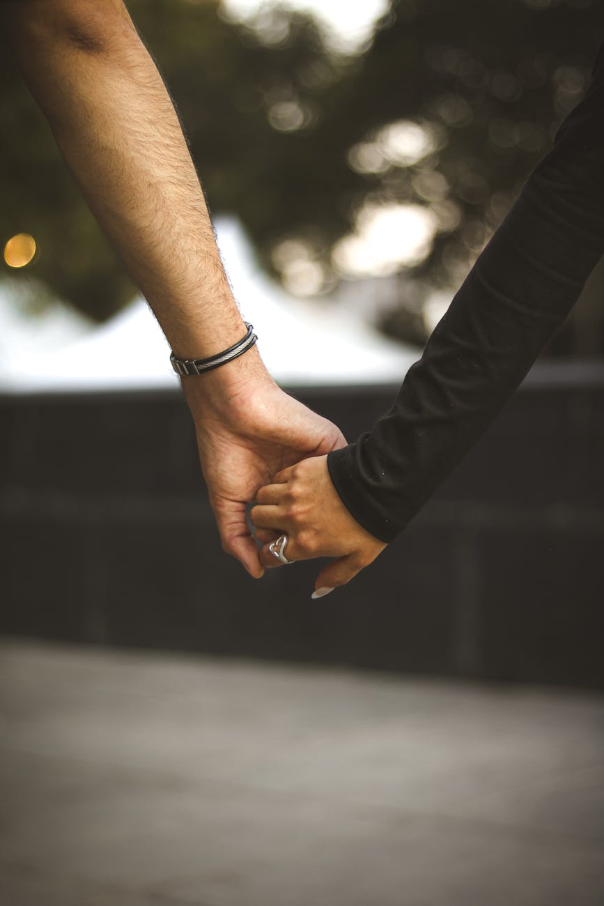 romantic couple holding hands outdoors