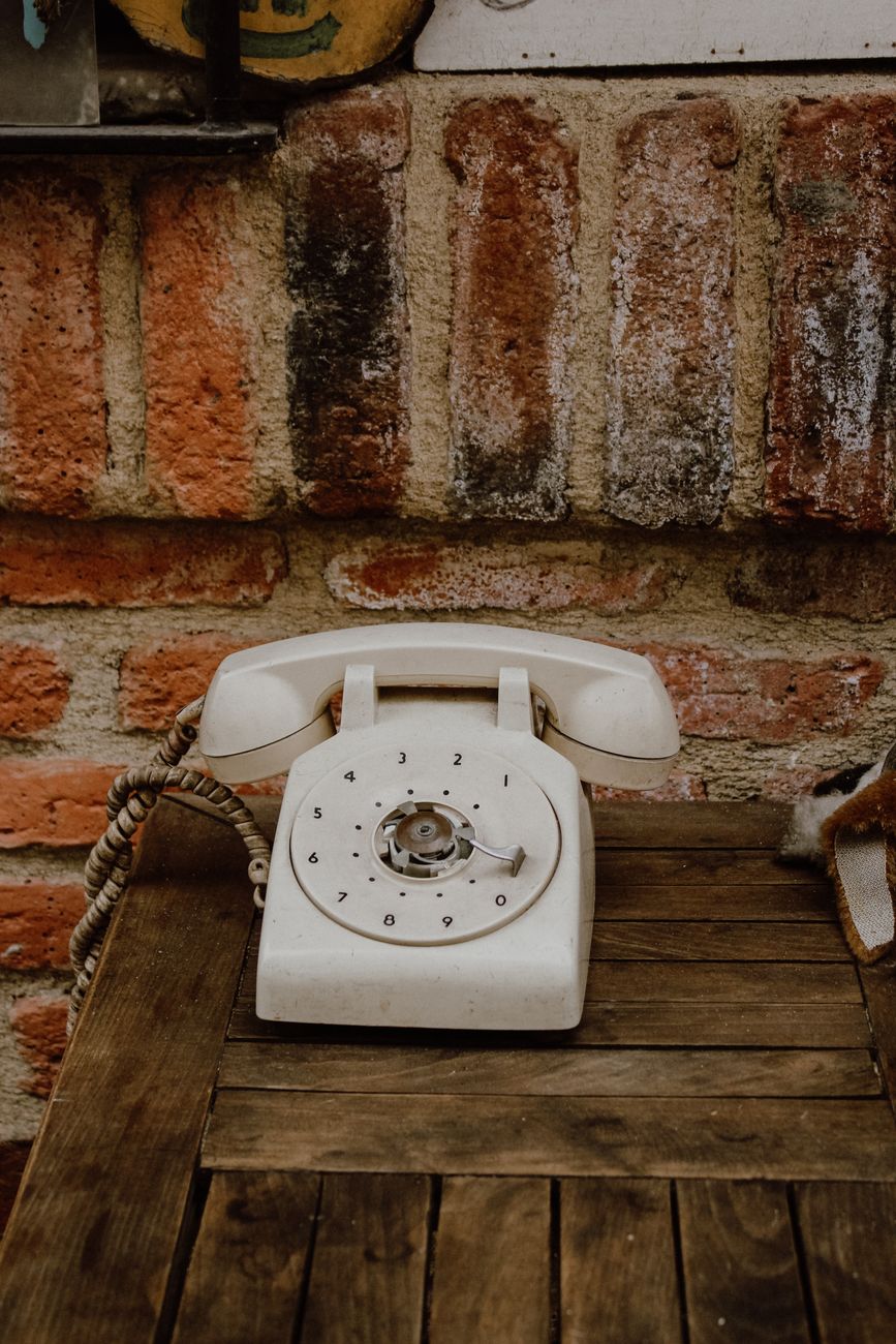 vintage rotary telephone on wooden table