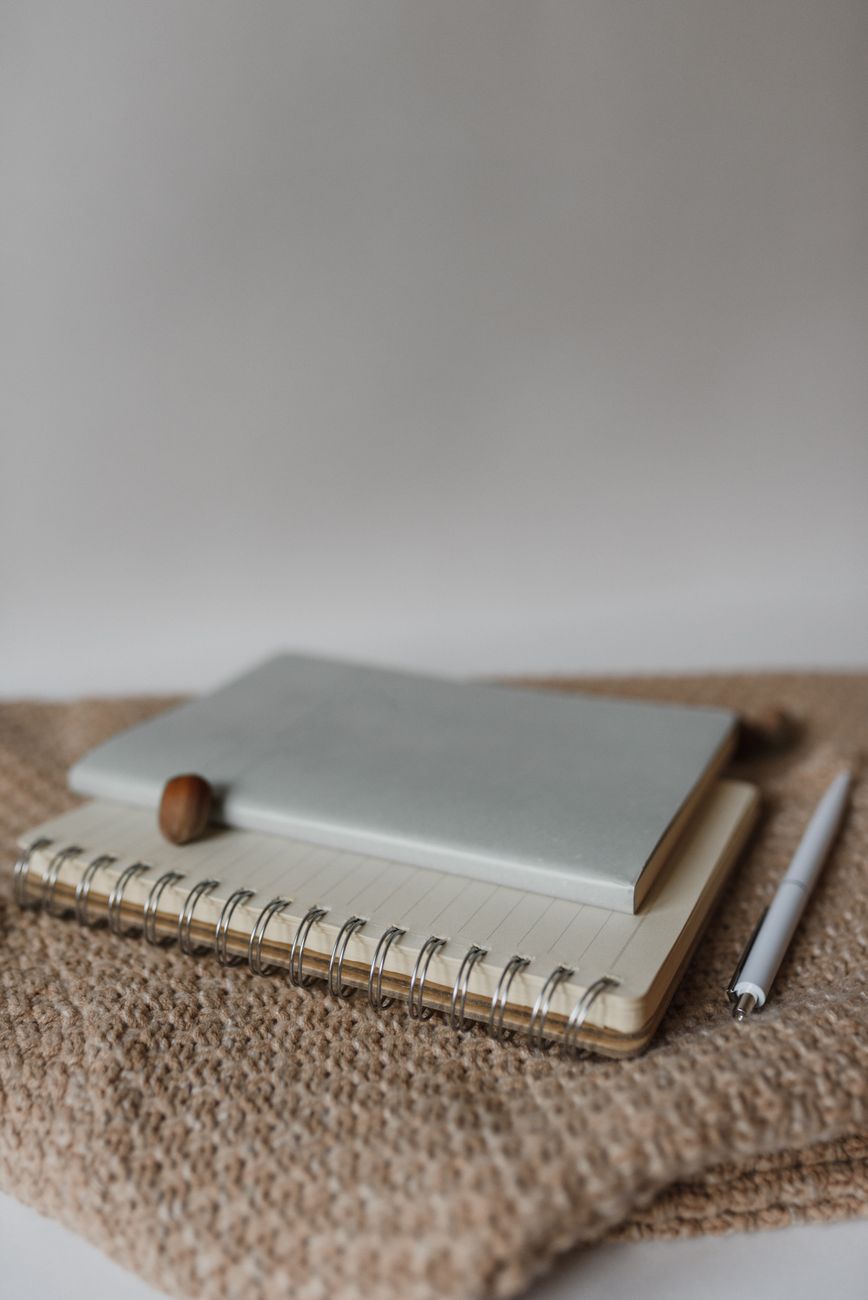 a notebook and pen on the sweater