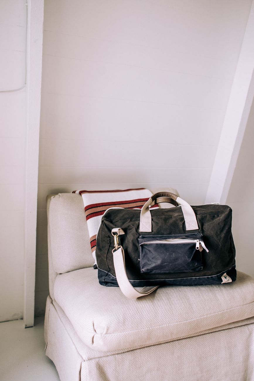 black leather bag on white sofa