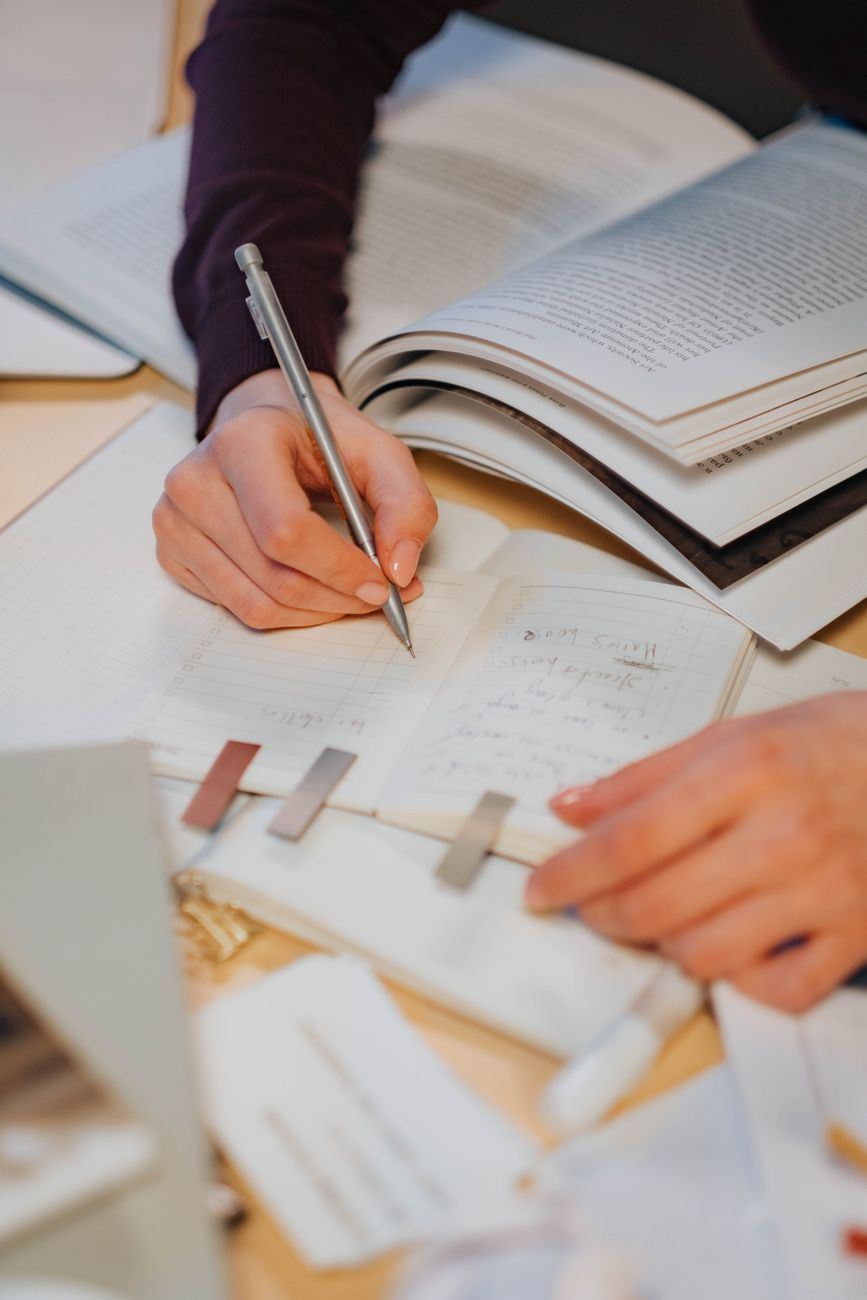 person writing on white paper